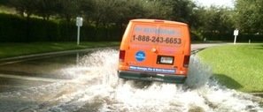 Van Driving Down Flooded Street